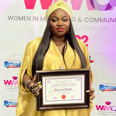 Motunrayo Babalola holding her certificate of recognition at the Women in Marketing and Communications awards